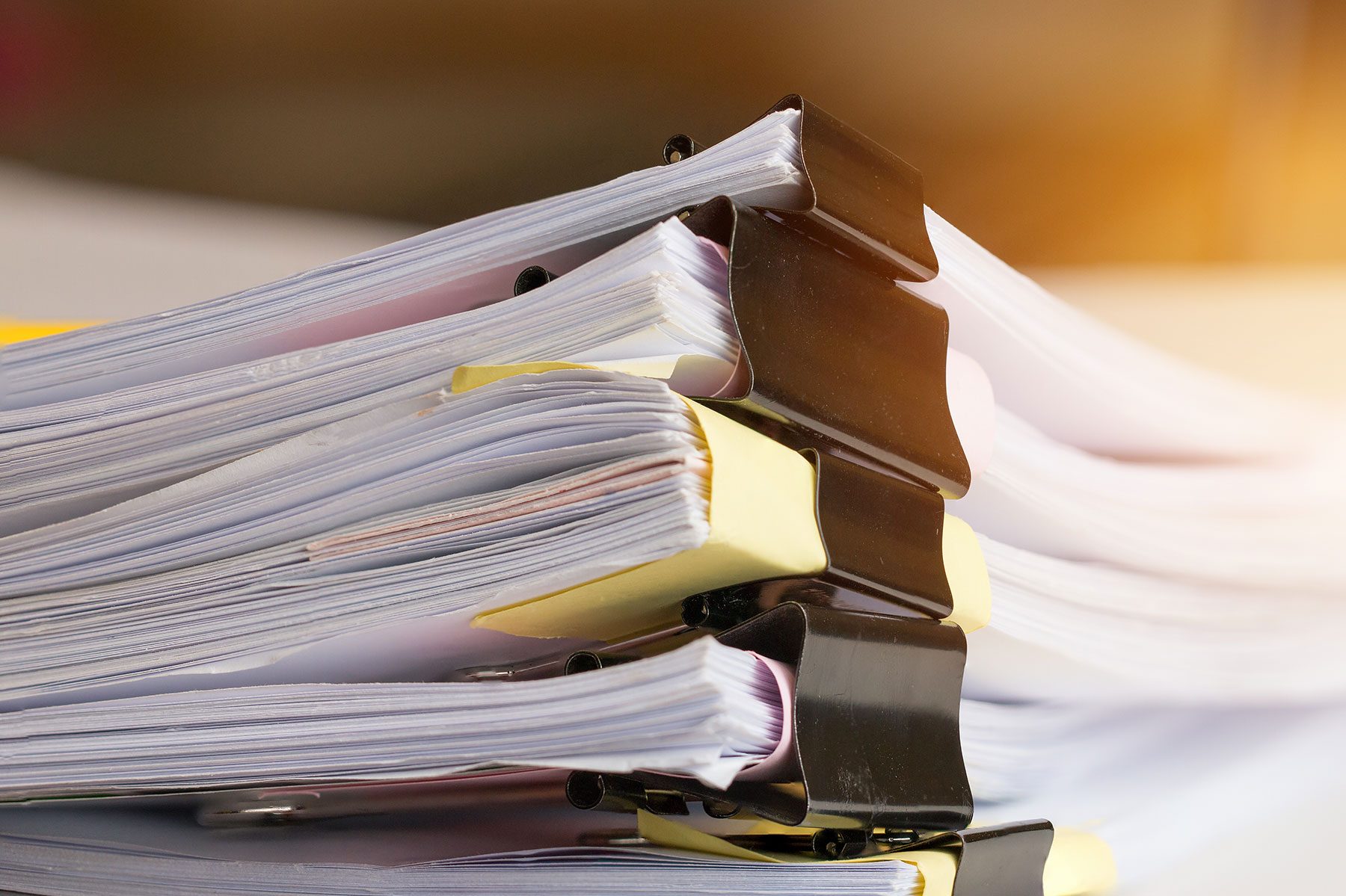 Case files and ring binders stacked on a desk
